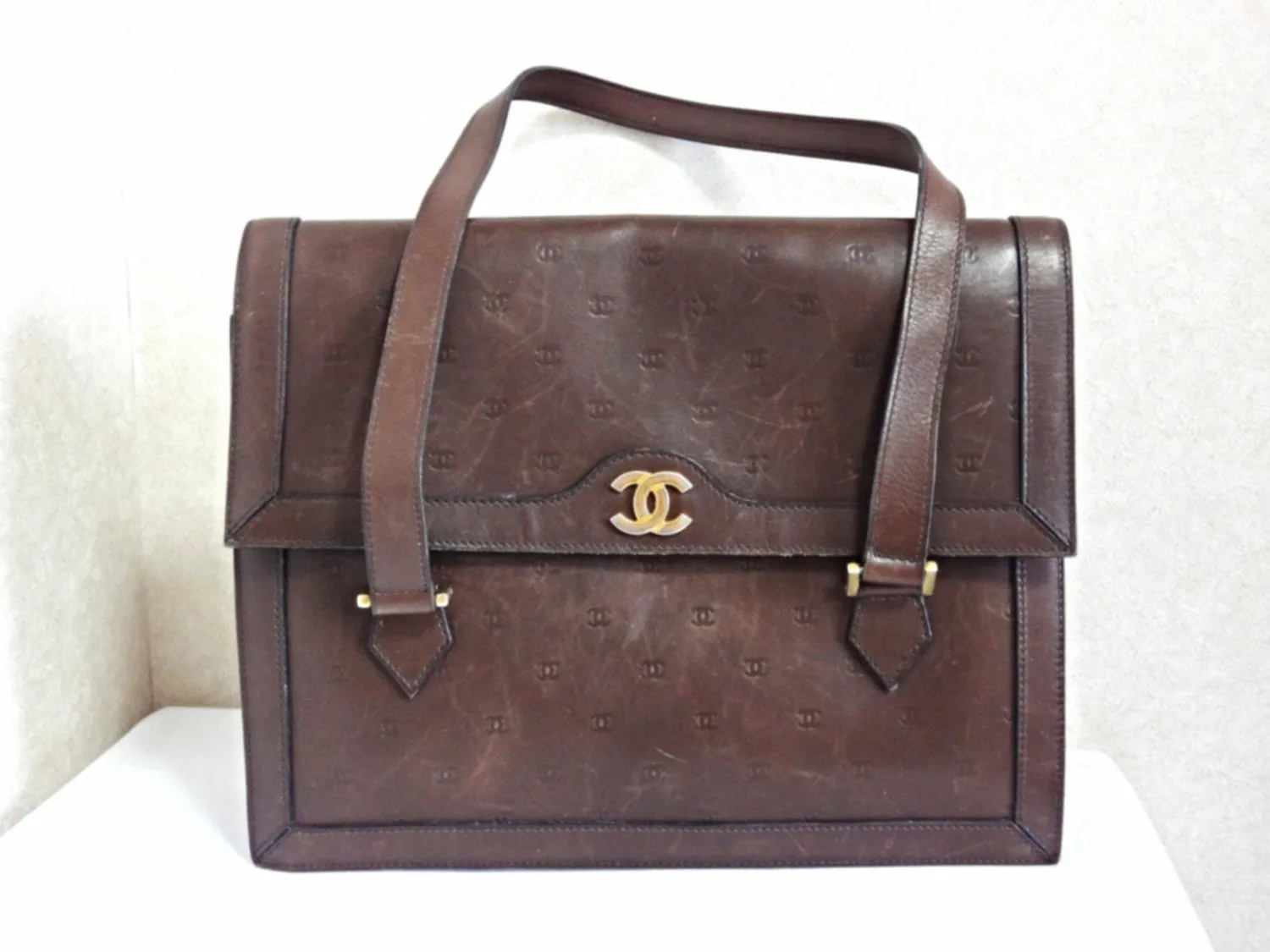 70s, 80s vintage CHANEL cocoa brown calfskin handbag with gold tone CC motif and mini CC motifs allover. Rare masterpiece  back in the era.